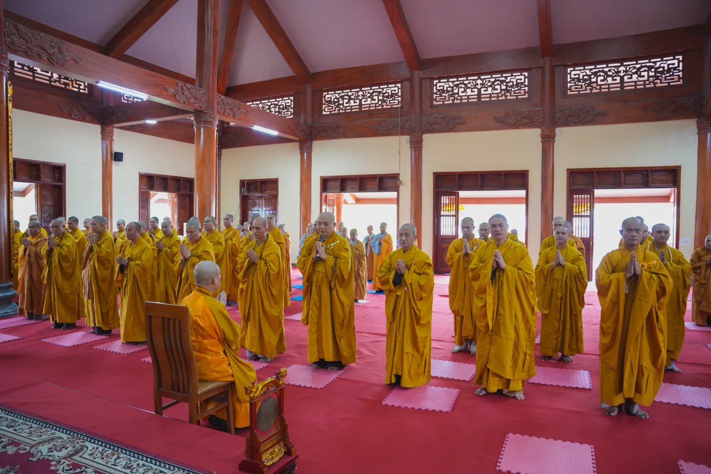 A group of people in yellow robes Description automatically generated