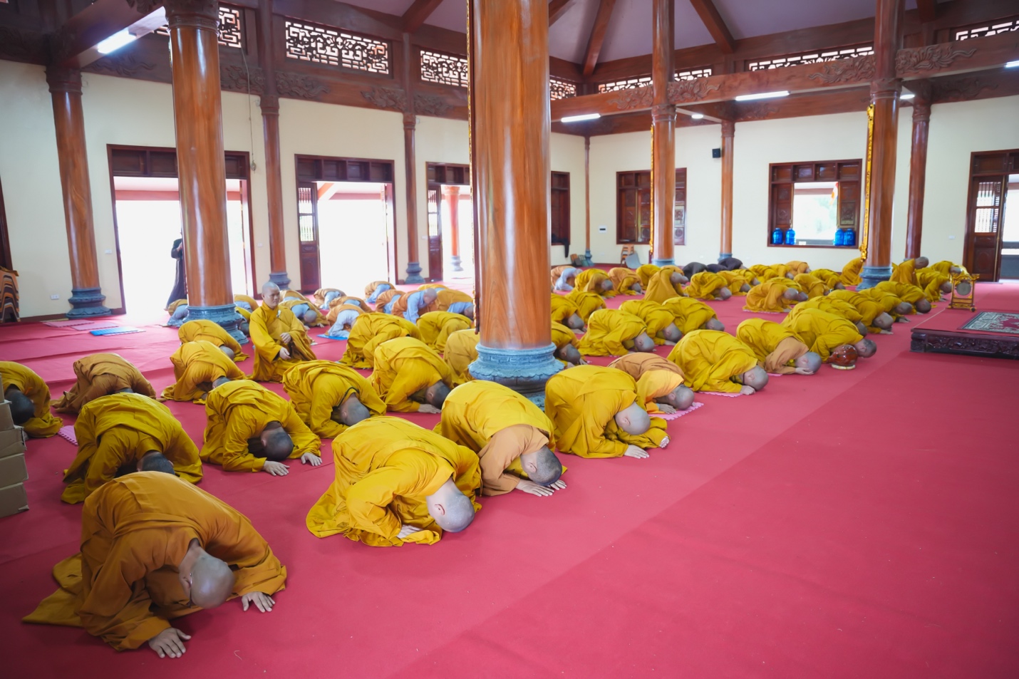 A group of people in yellow robes Description automatically generated