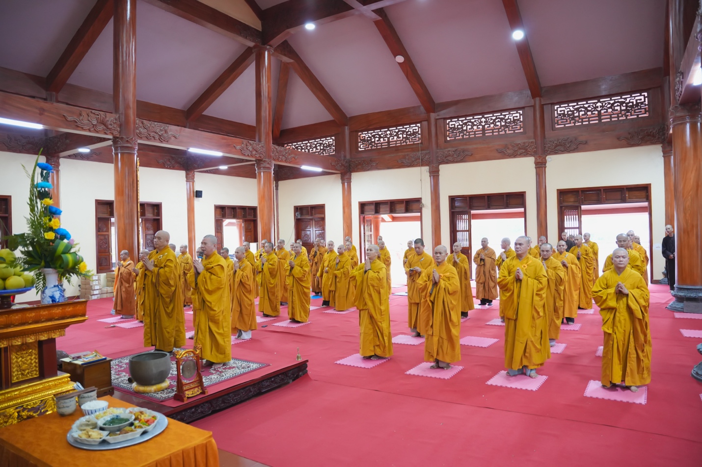 A group of people in yellow robes Description automatically generated