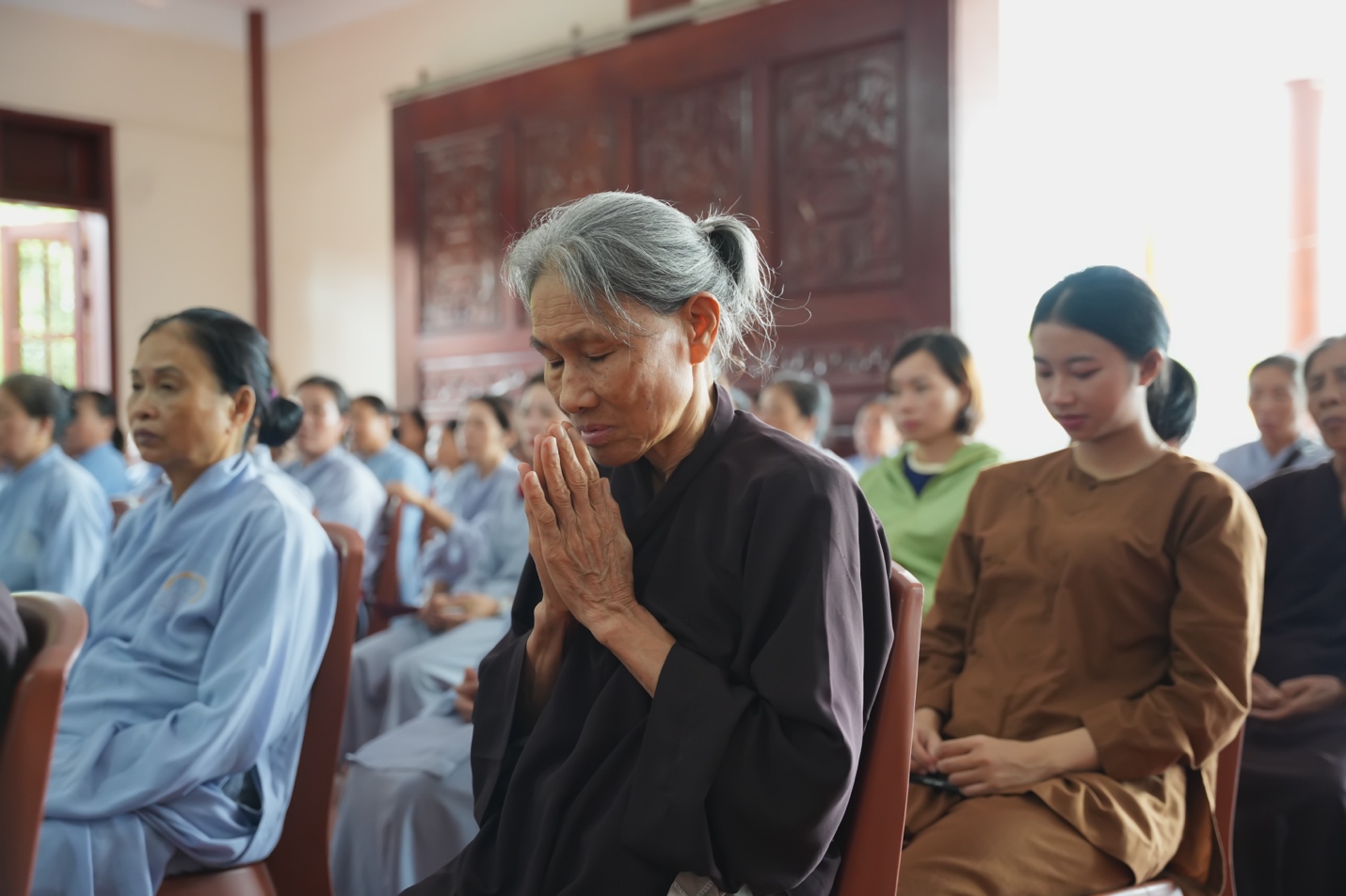 A group of people praying Description automatically generated