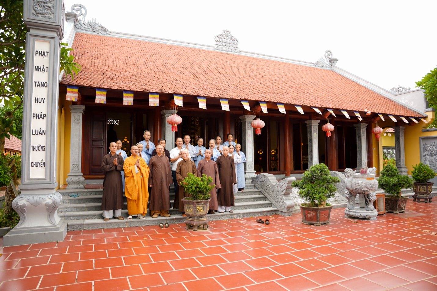 A group of people standing outside a building Description automatically generated