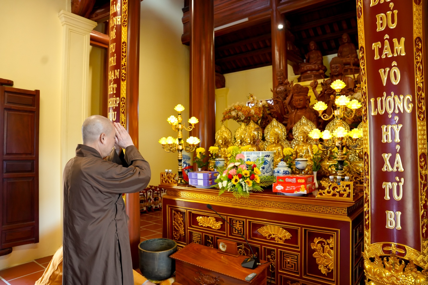 A person standing in front of a shrine Description automatically generated