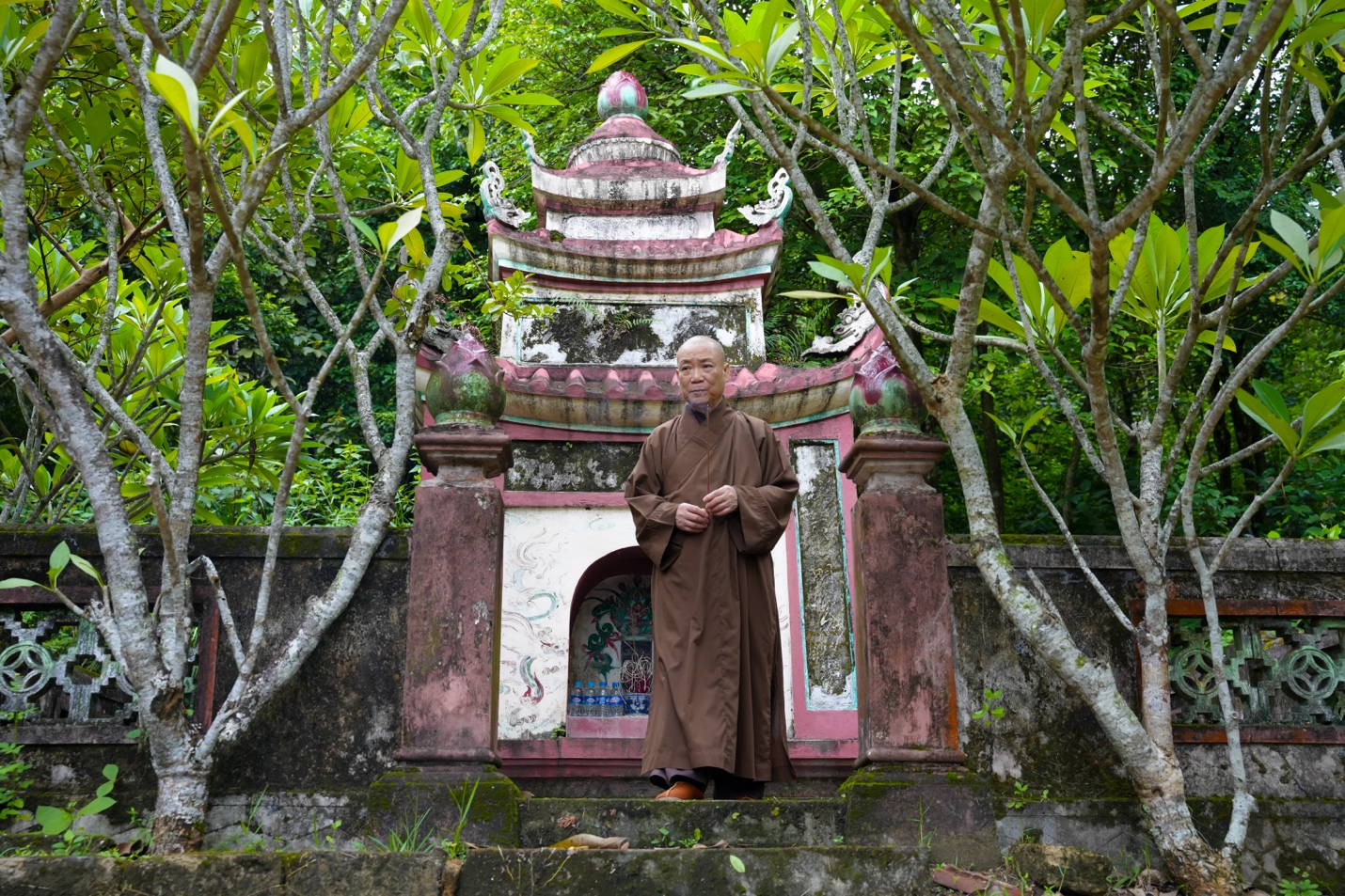 A person standing in front of a temple Description automatically generated