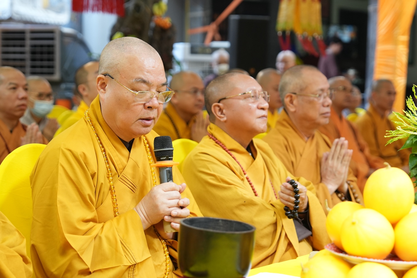 A group of men in yellow robes Description automatically generated