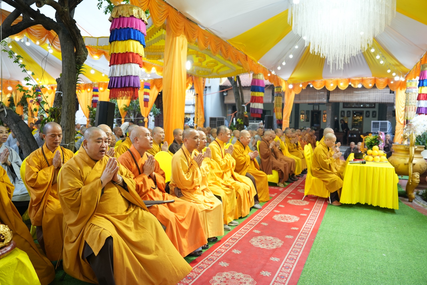 A group of people in yellow robes Description automatically generated