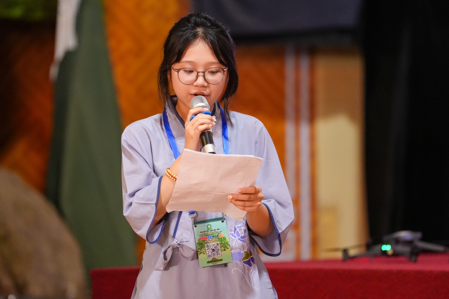 A child holding a microphone and looking at paper AI-generated content may be incorrect.