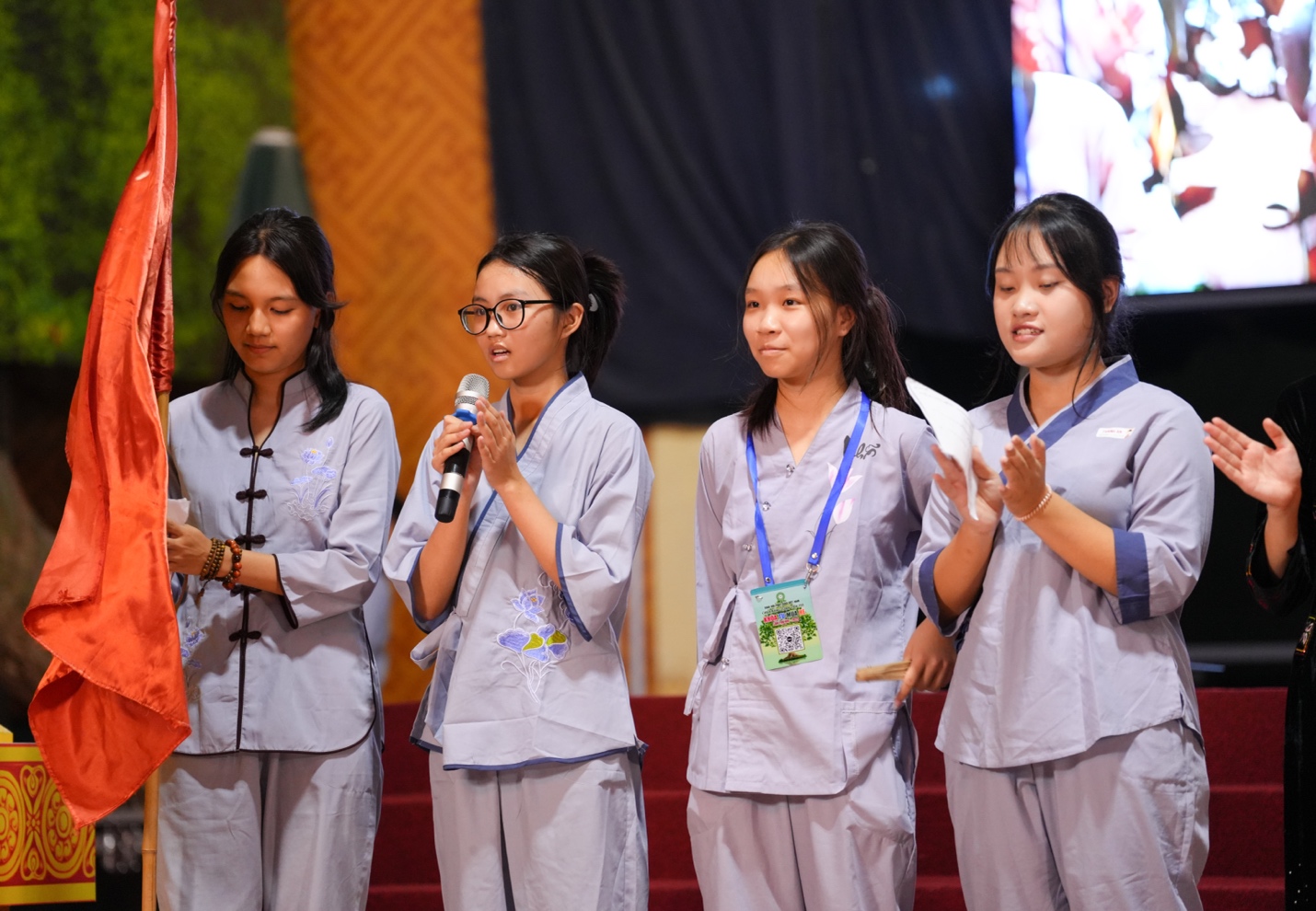 A group of girls standing on a stage AI-generated content may be incorrect.