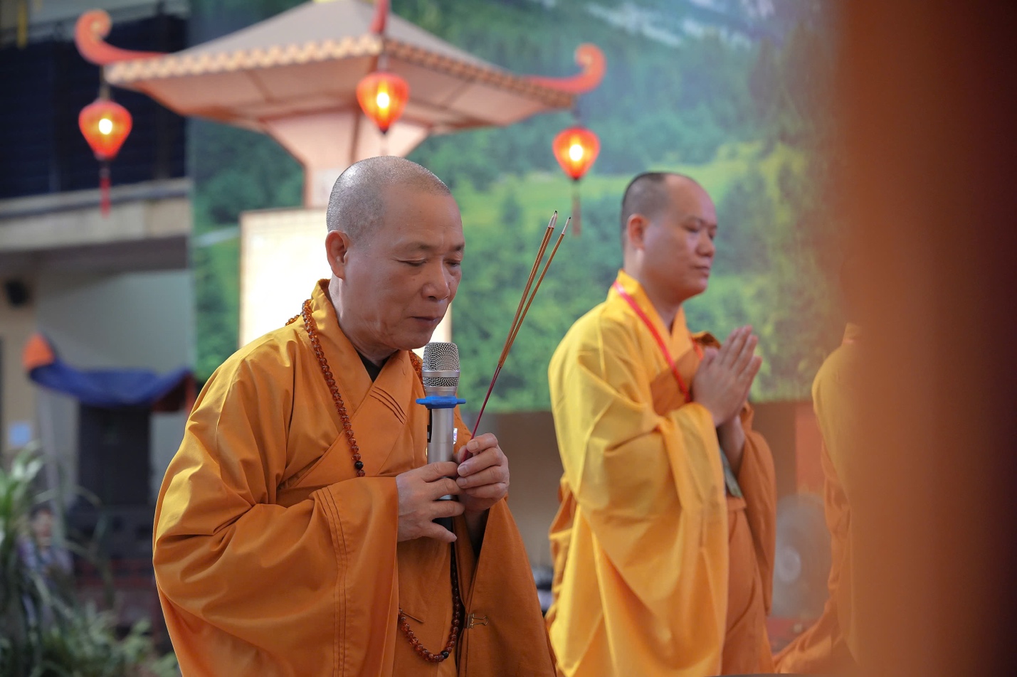A group of men in robes holding a microphone AI-generated content may be incorrect.