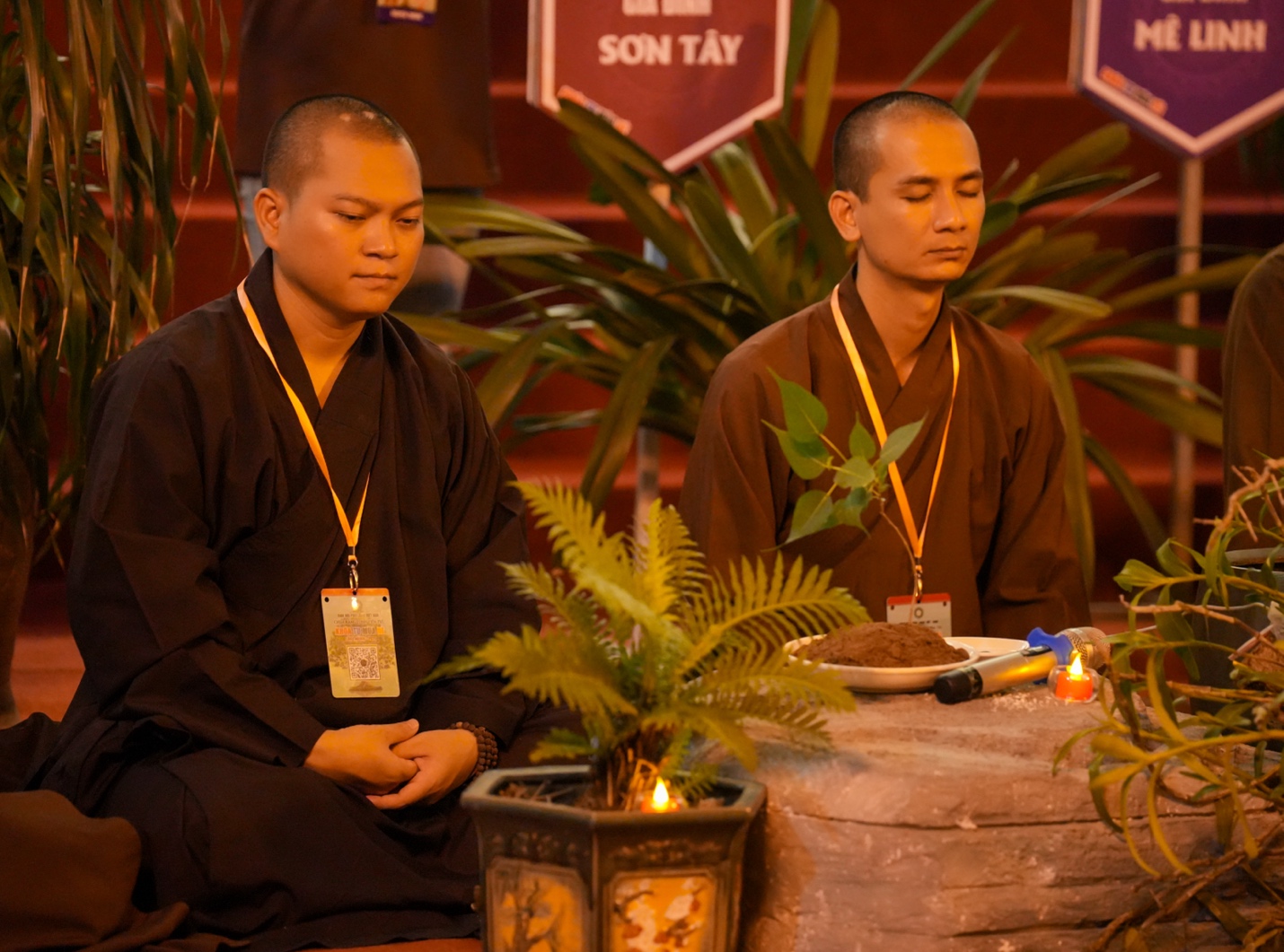 A group of men sitting in front of a plant AI-generated content may be incorrect.