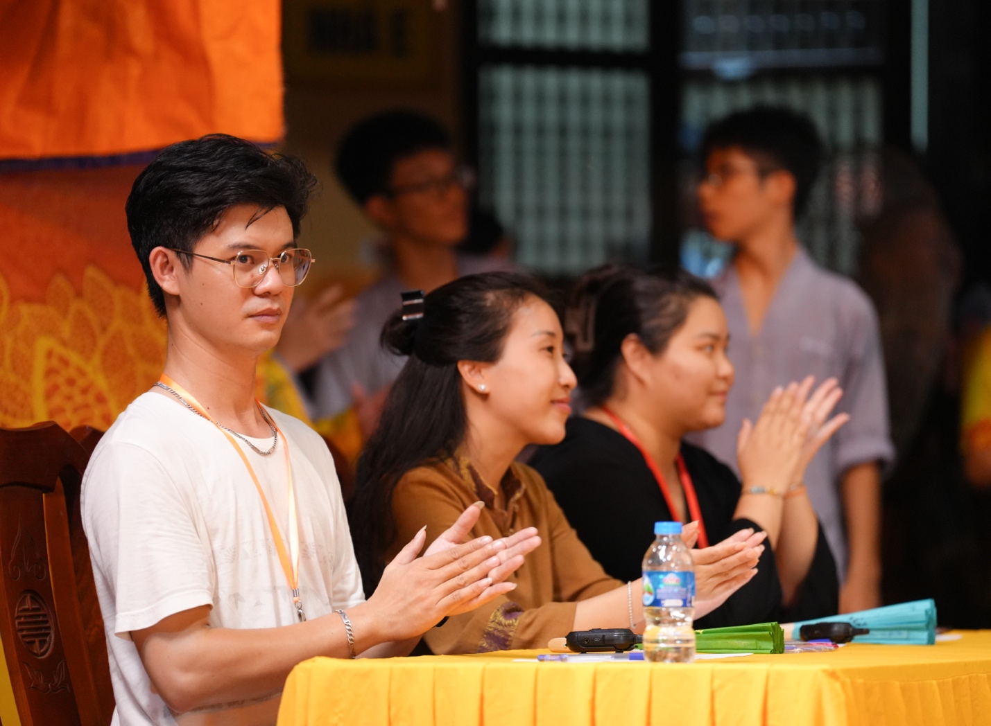A group of people clapping at a table AI-generated content may be incorrect.