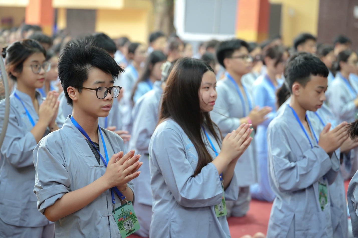 A group of people in a prayer pose AI-generated content may be incorrect.