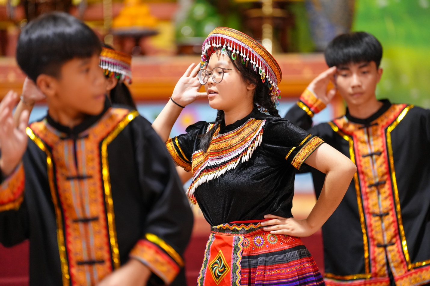 A group of people in traditional clothing AI-generated content may be incorrect.