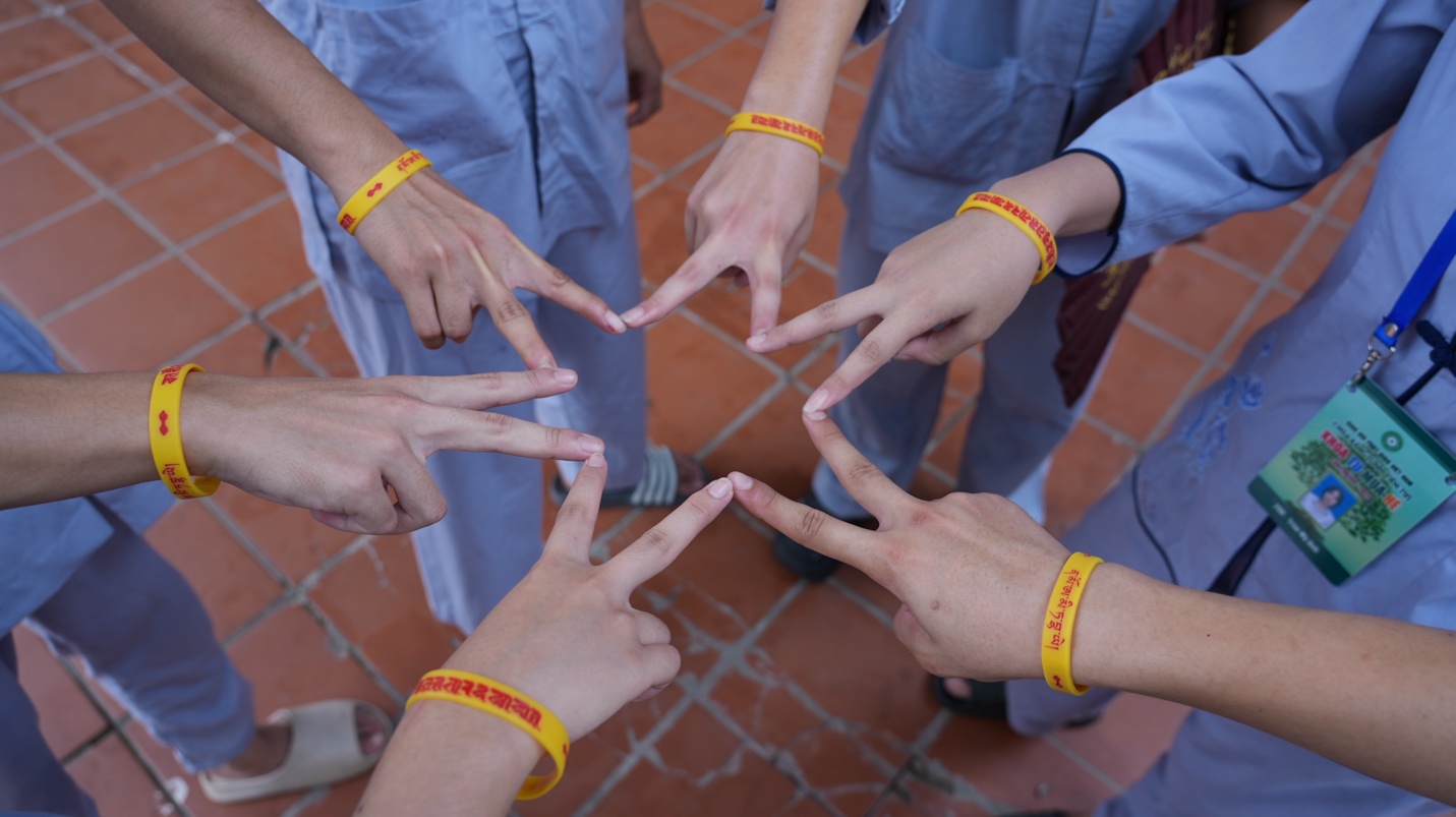 A group of people making a star with their hands AI-generated content may be incorrect.