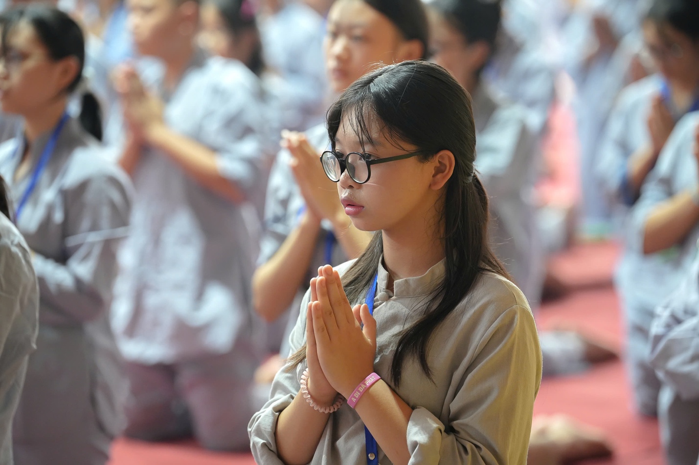 A group of people praying AI-generated content may be incorrect.