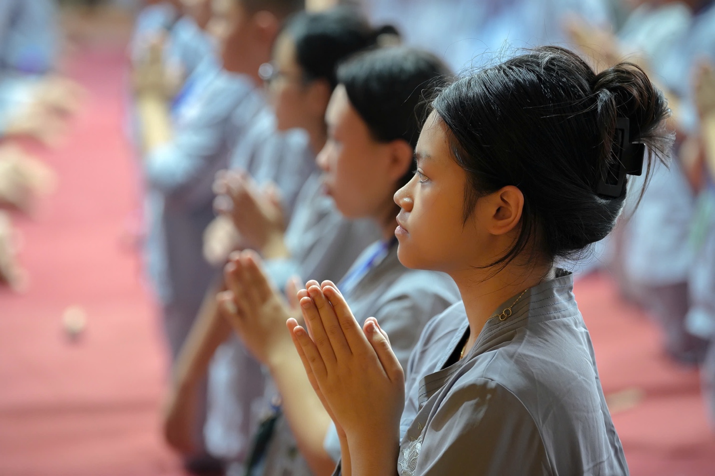 A group of people praying AI-generated content may be incorrect.