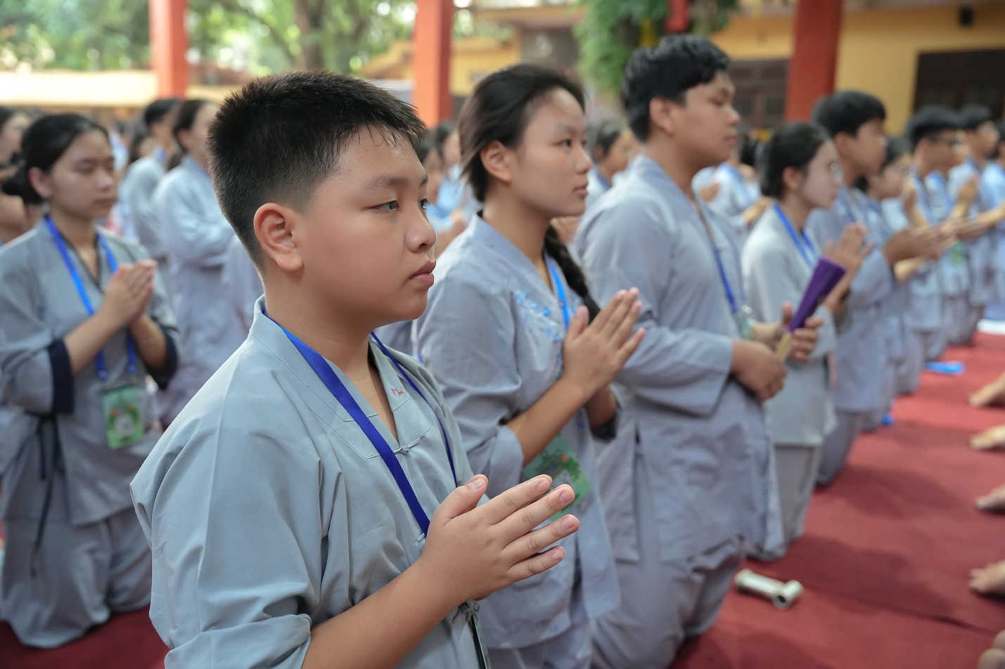 A group of people praying AI-generated content may be incorrect.