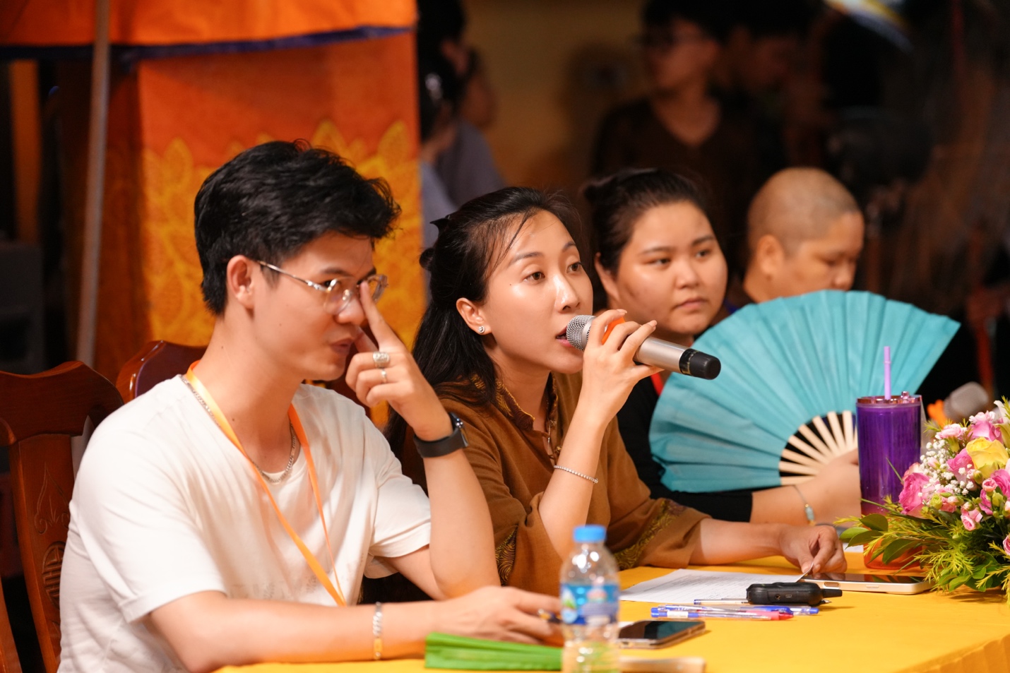 A group of people sitting at a table AI-generated content may be incorrect.