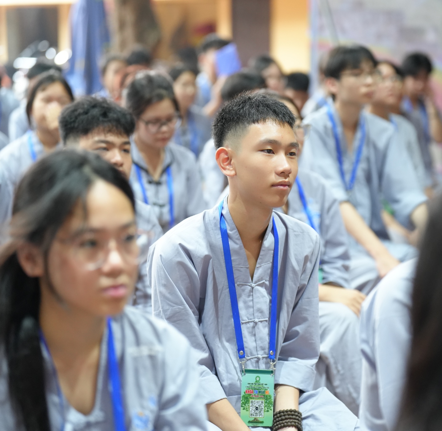 A group of people sitting in a room AI-generated content may be incorrect.