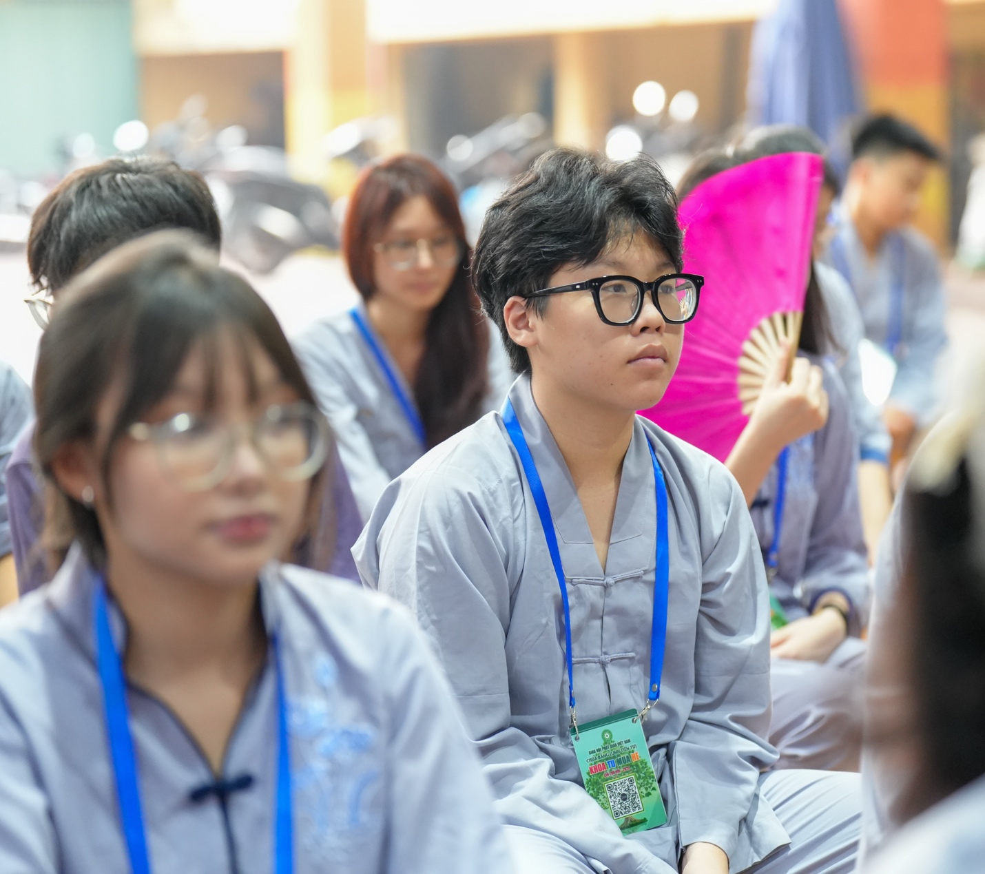 A group of people sitting in a room AI-generated content may be incorrect.