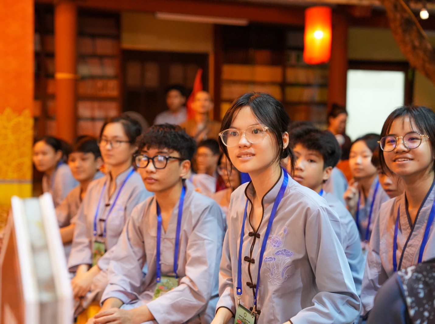 A group of people sitting in a room AI-generated content may be incorrect.