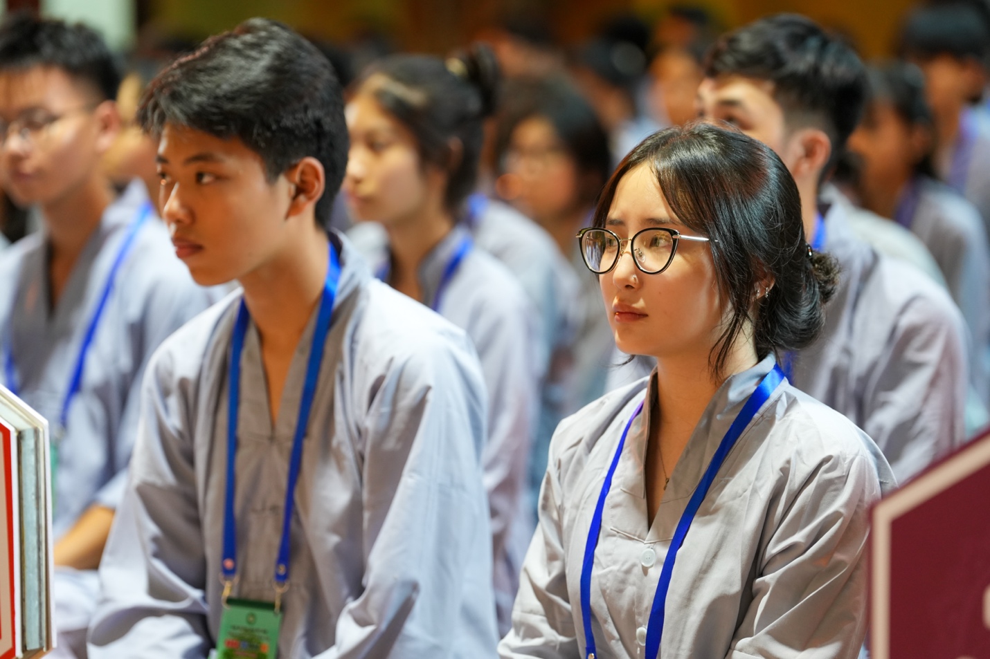 A group of people sitting in a room AI-generated content may be incorrect.