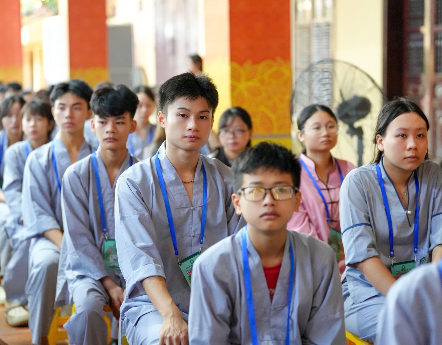 A group of people sitting in a room AI-generated content may be incorrect.