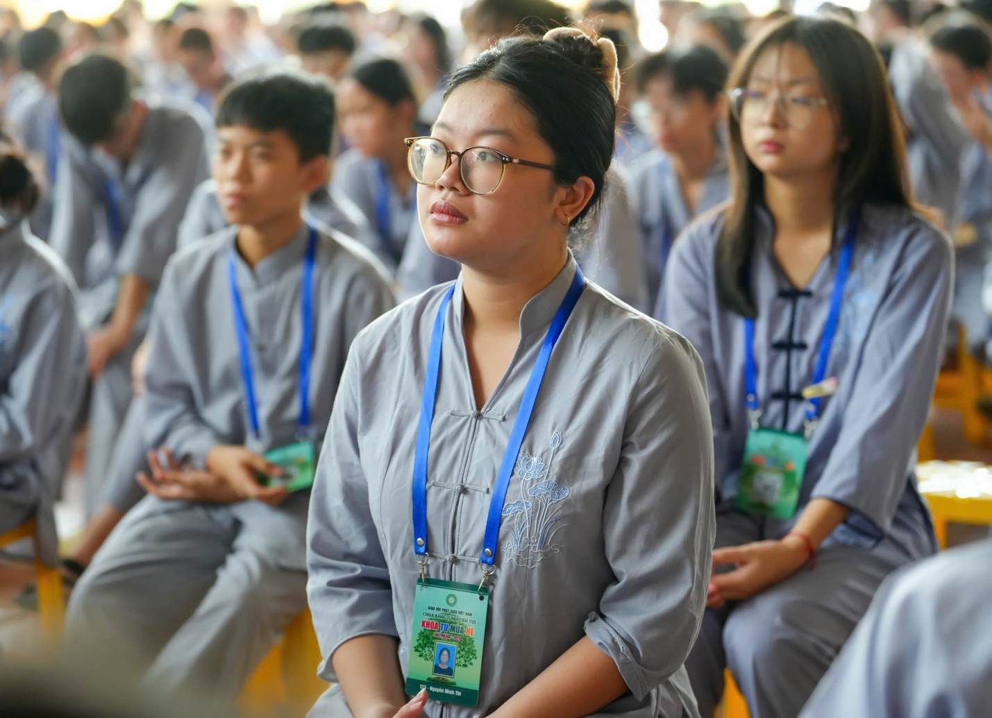A group of people sitting in a room AI-generated content may be incorrect.