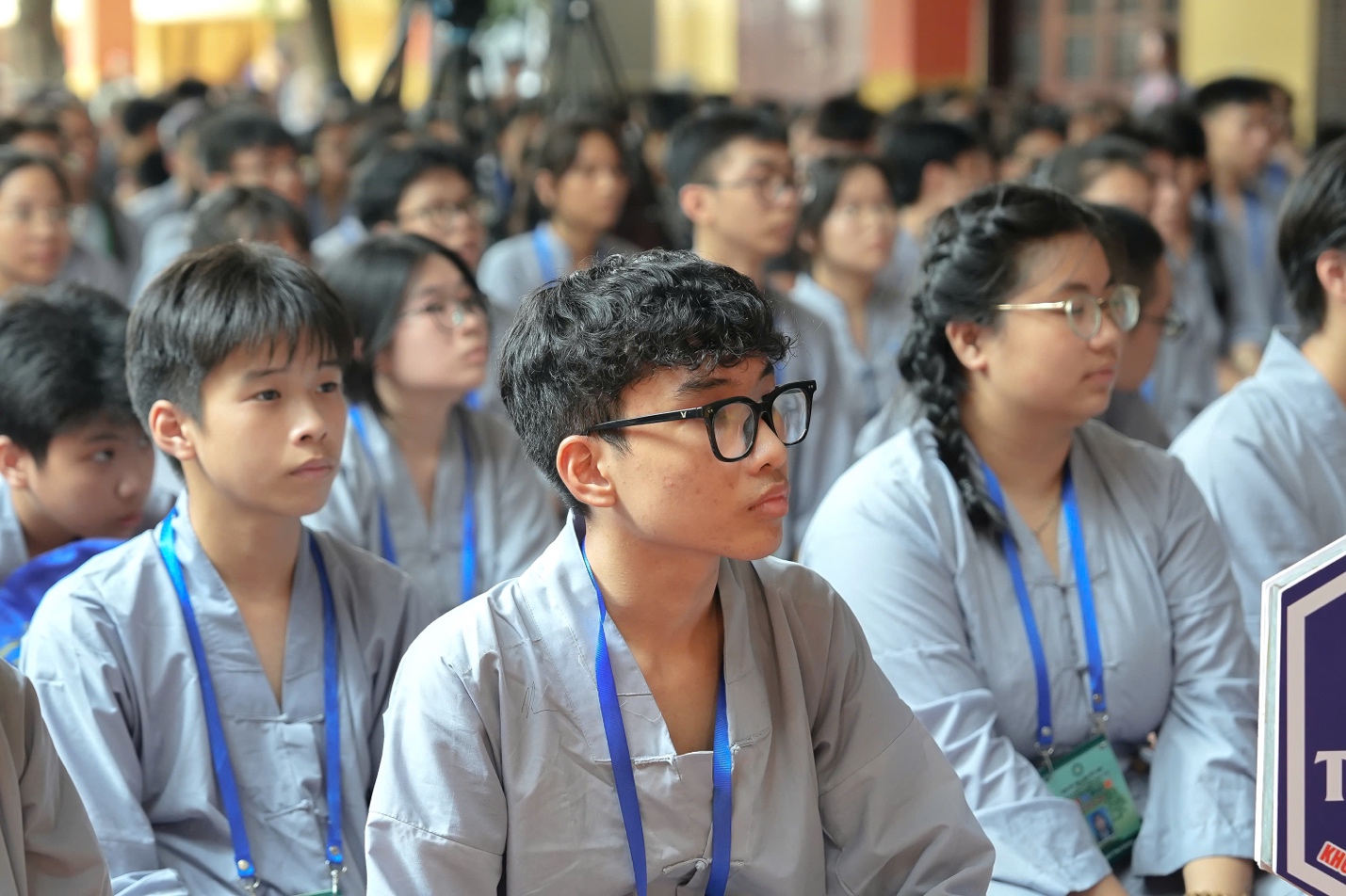 A group of people sitting in a room AI-generated content may be incorrect.