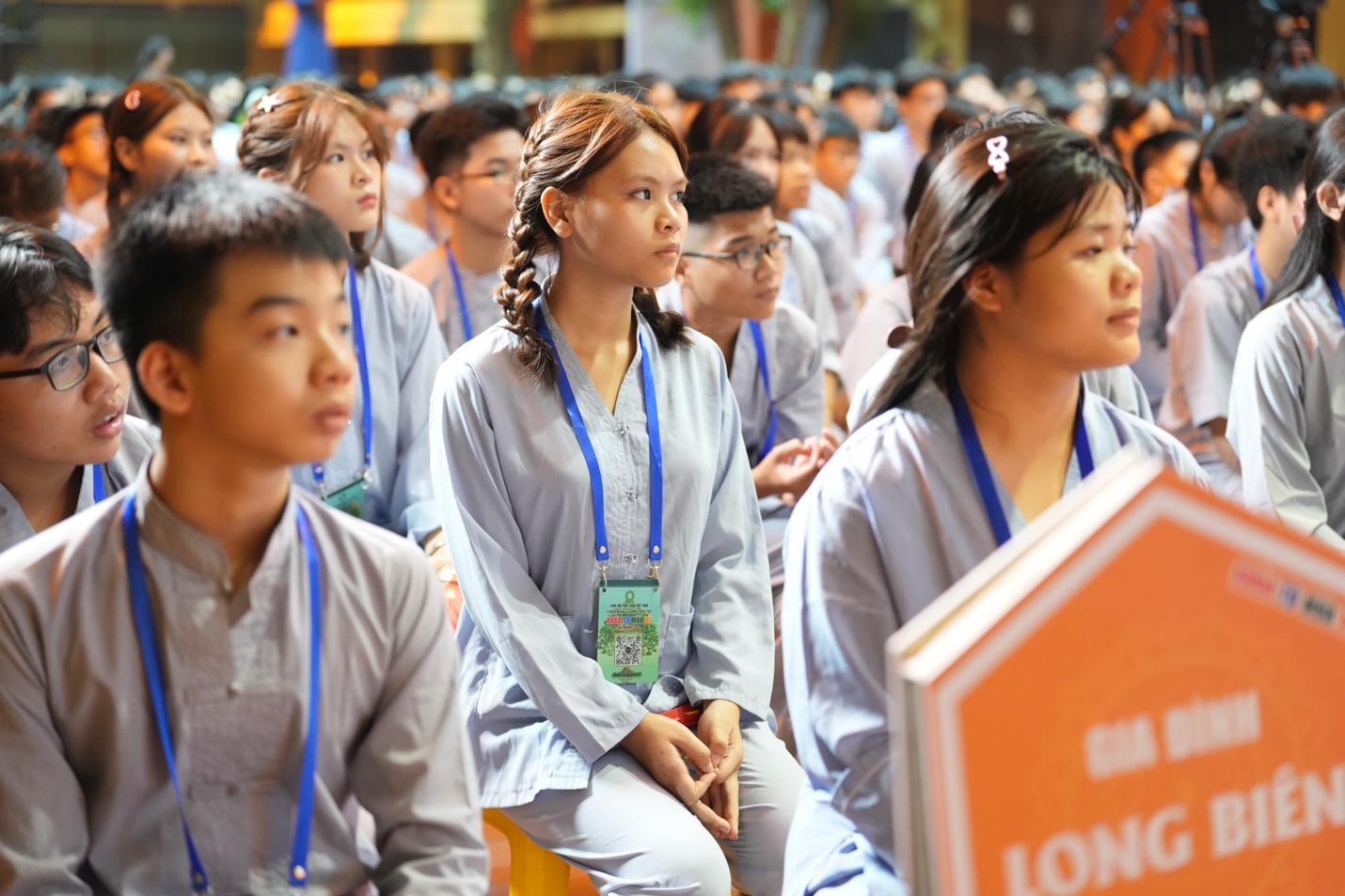 A group of people sitting in a row AI-generated content may be incorrect.