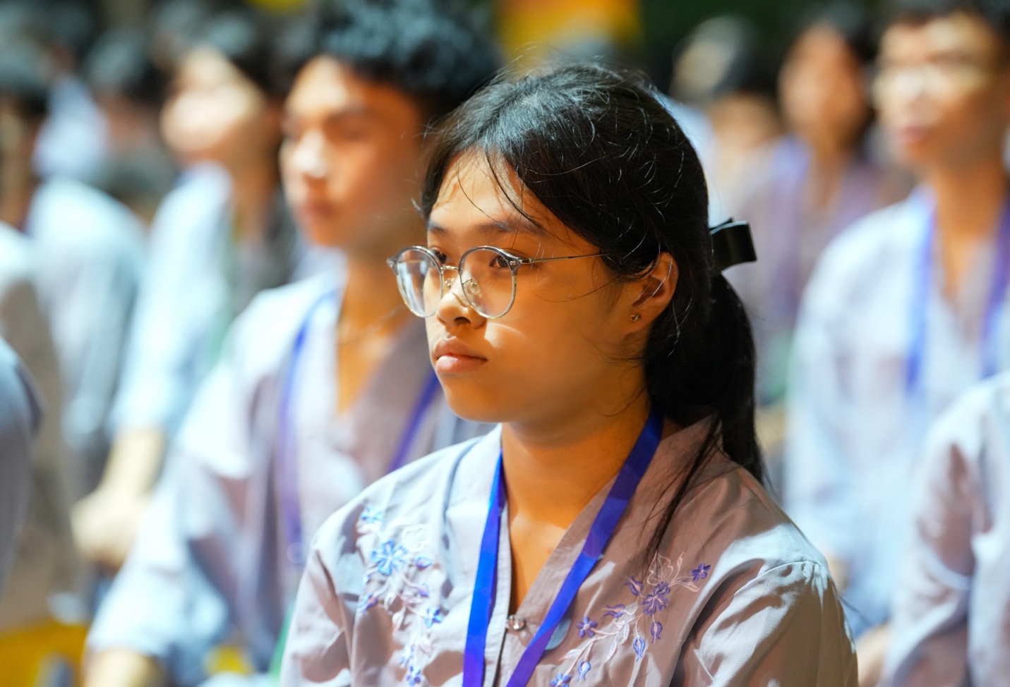 A group of people sitting in a row AI-generated content may be incorrect.