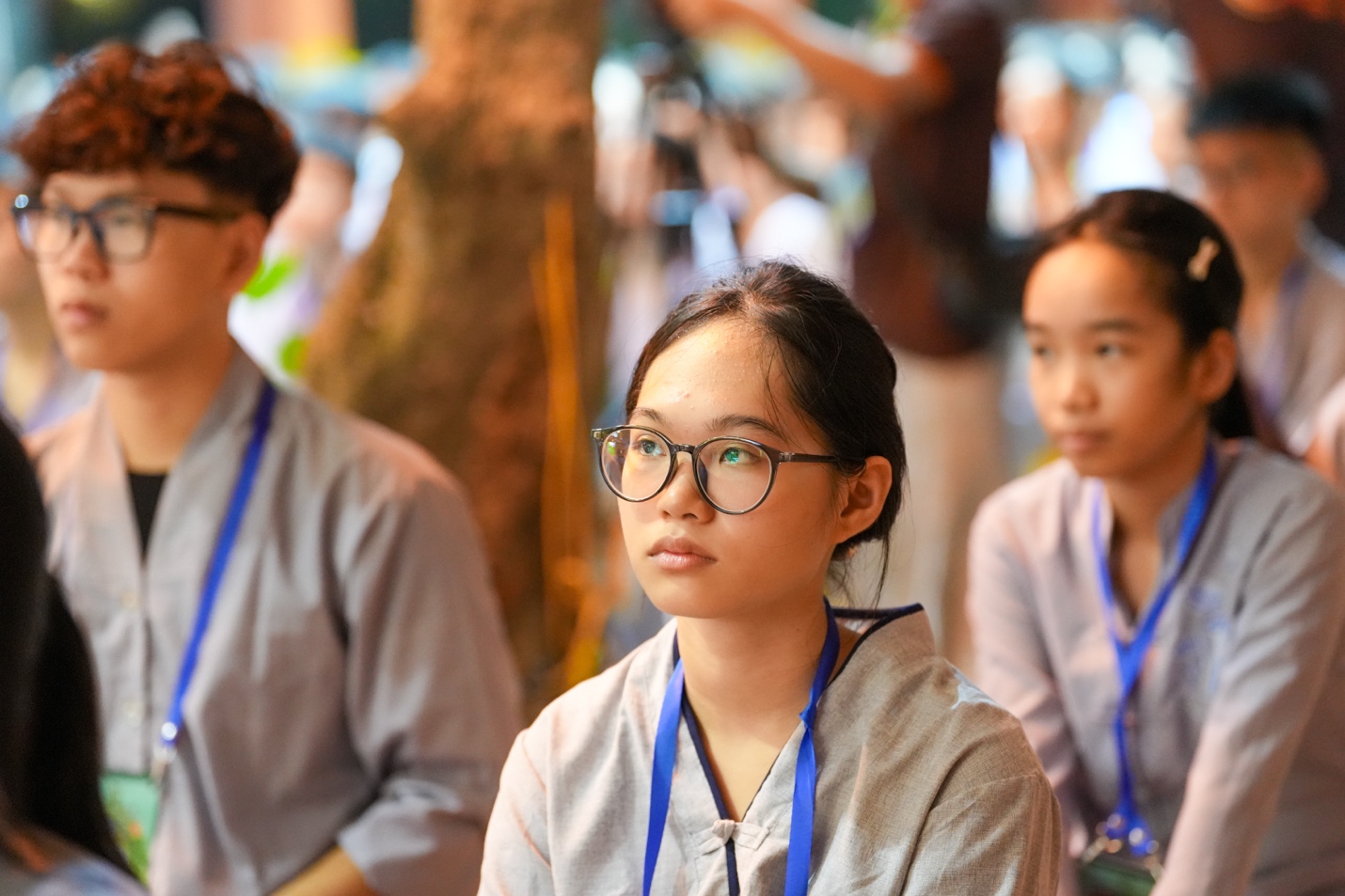 A group of people sitting in a row AI-generated content may be incorrect.