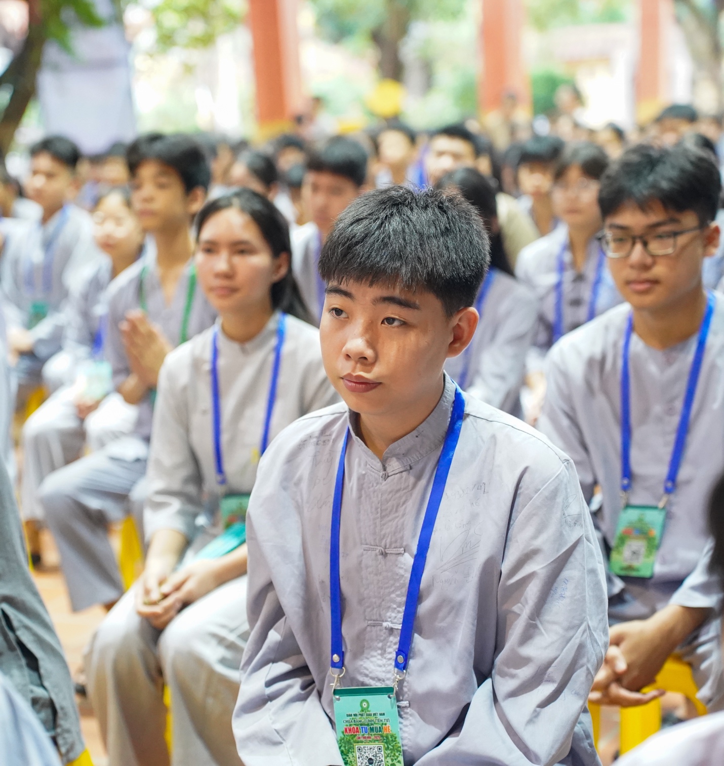 A group of people sitting in a row AI-generated content may be incorrect.