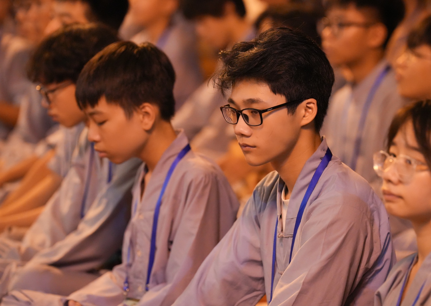 A group of people sitting in a row AI-generated content may be incorrect.