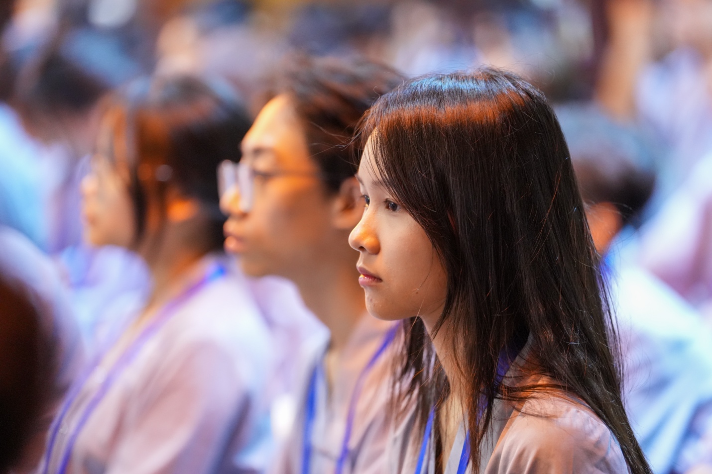 A group of people sitting in a row AI-generated content may be incorrect.