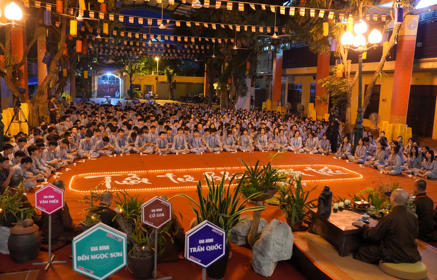 A group of people sitting on a red carpet AI-generated content may be incorrect.