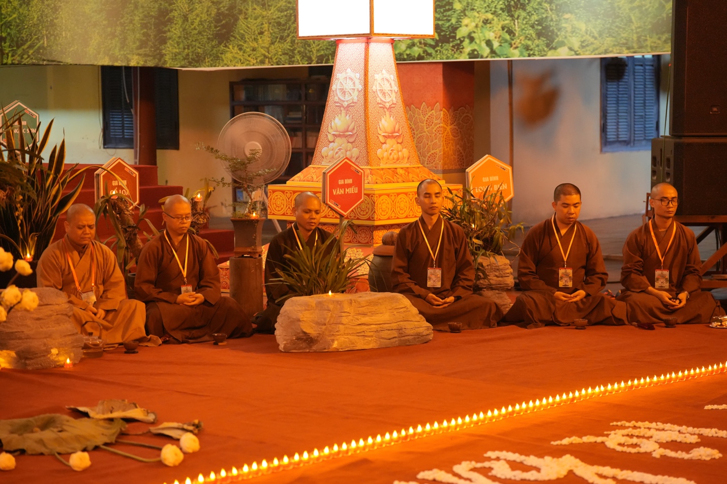 A group of people sitting on a stage AI-generated content may be incorrect.