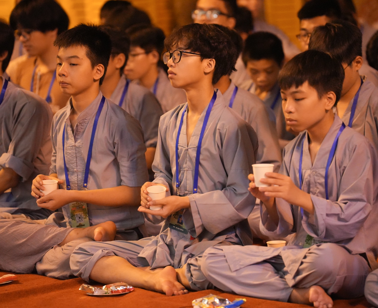 A group of people sitting on the floor AI-generated content may be incorrect.