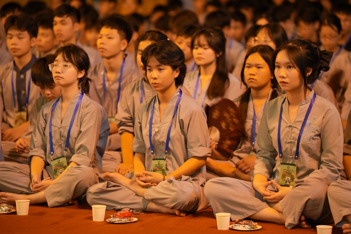 A group of people sitting on the floor AI-generated content may be incorrect.