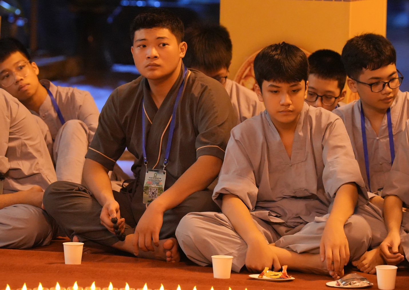 A group of people sitting on the floor AI-generated content may be incorrect.