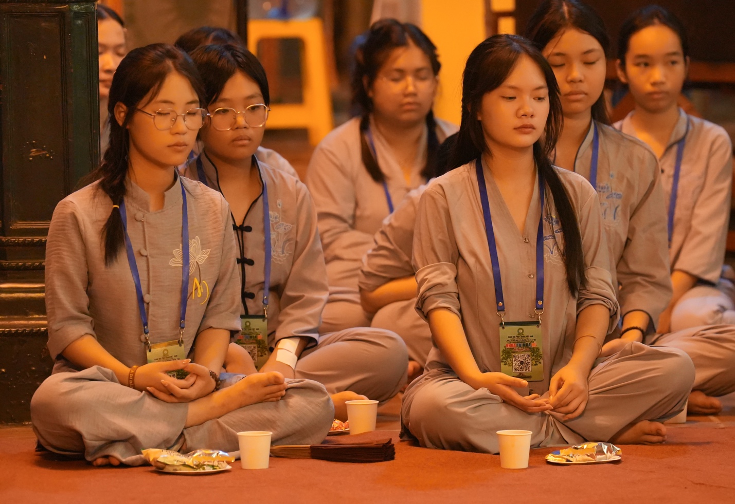 A group of people sitting on the floor AI-generated content may be incorrect.
