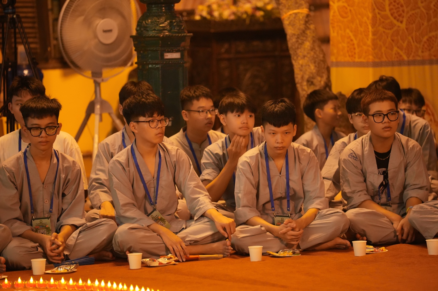 A group of people sitting on the floor AI-generated content may be incorrect.