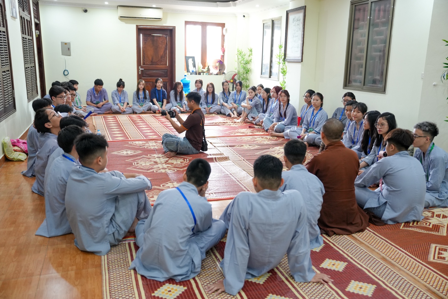 A group of people sitting on the floor AI-generated content may be incorrect.
