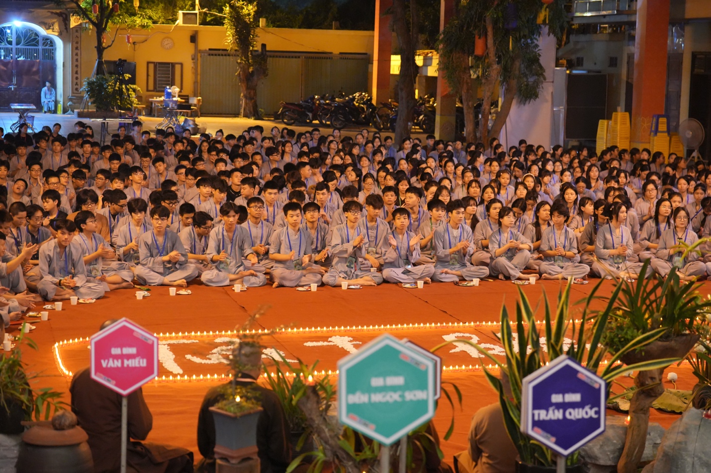 A group of people sitting on the ground AI-generated content may be incorrect.