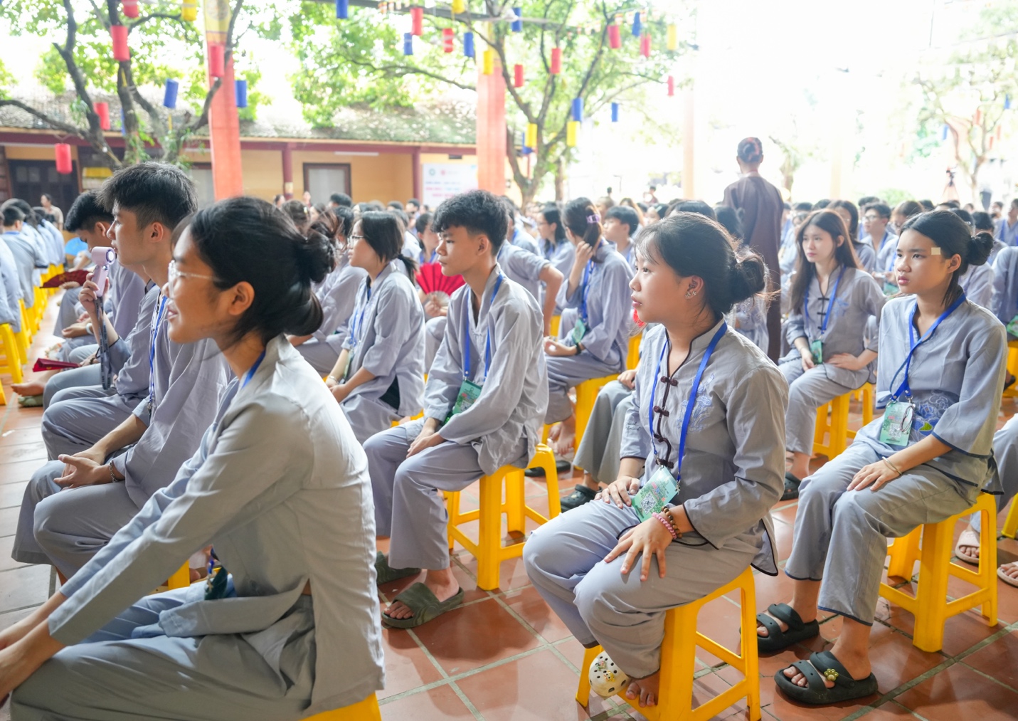 A group of people sitting on yellow chairs AI-generated content may be incorrect.