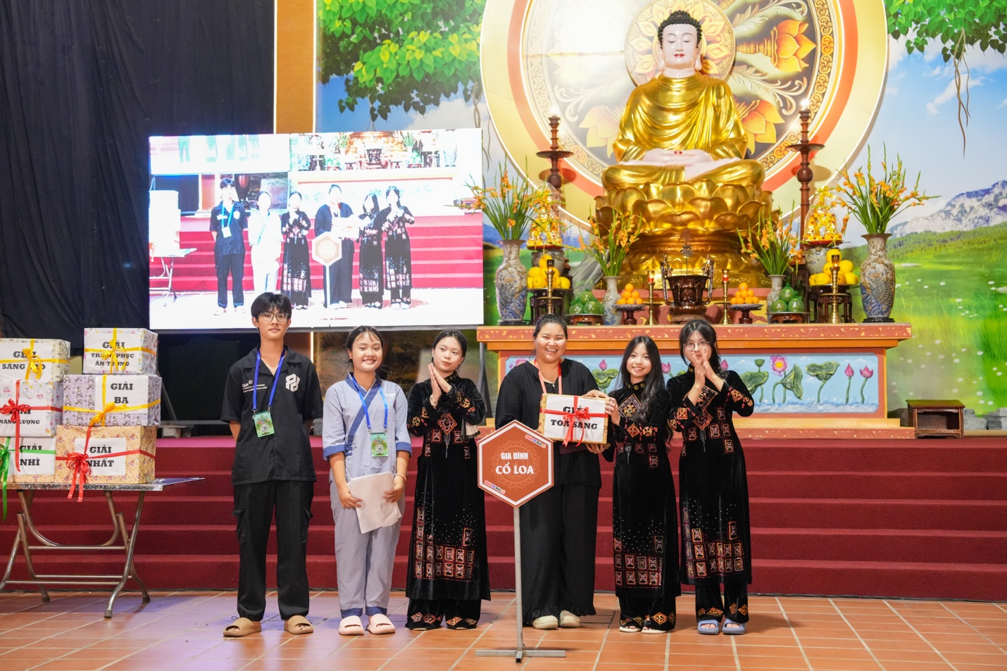 A group of people standing in front of a gold statue AI-generated content may be incorrect.