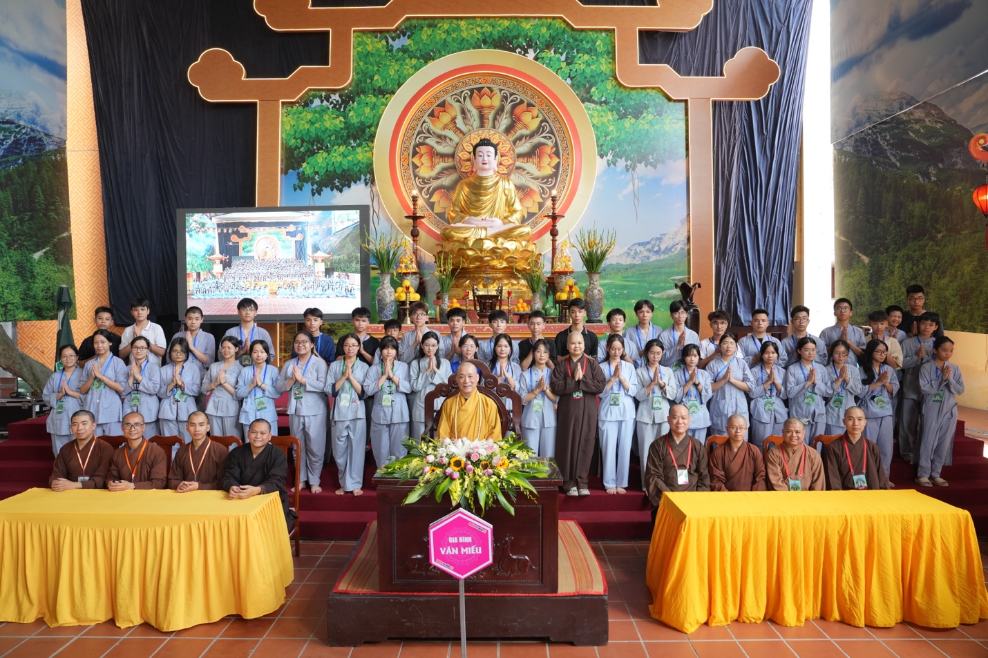 A group of people standing in front of a large group of people AI-generated content may be incorrect.