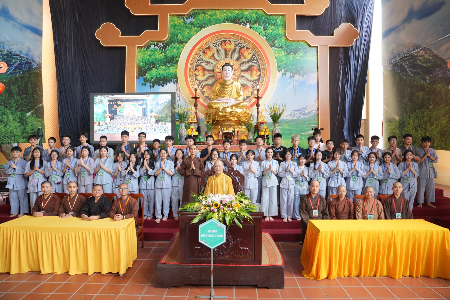 A group of people standing in front of a large group of people AI-generated content may be incorrect.