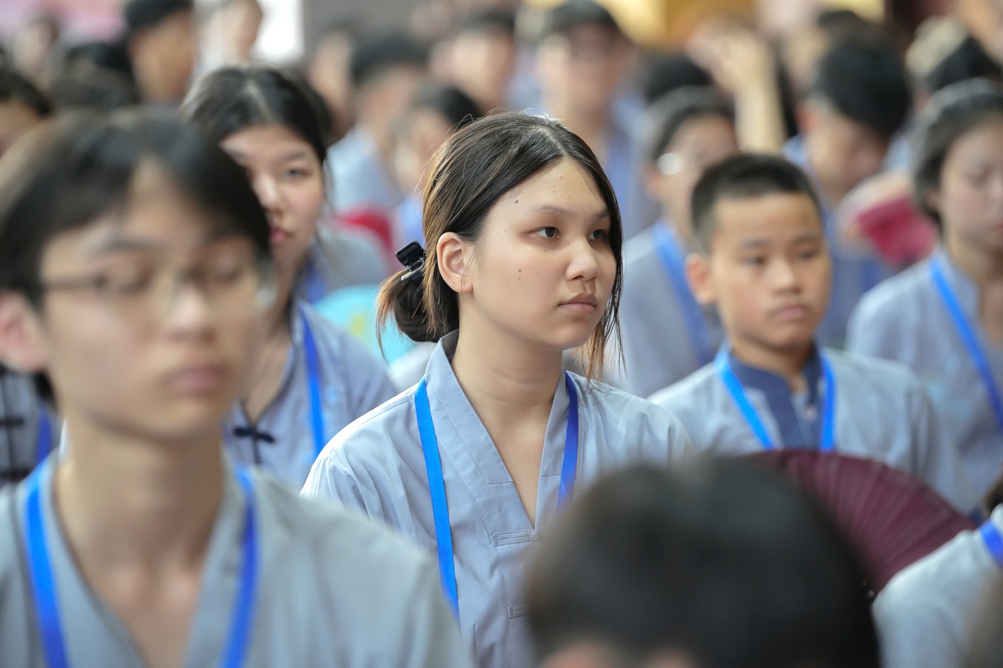 A group of people wearing blue lanyards AI-generated content may be incorrect.