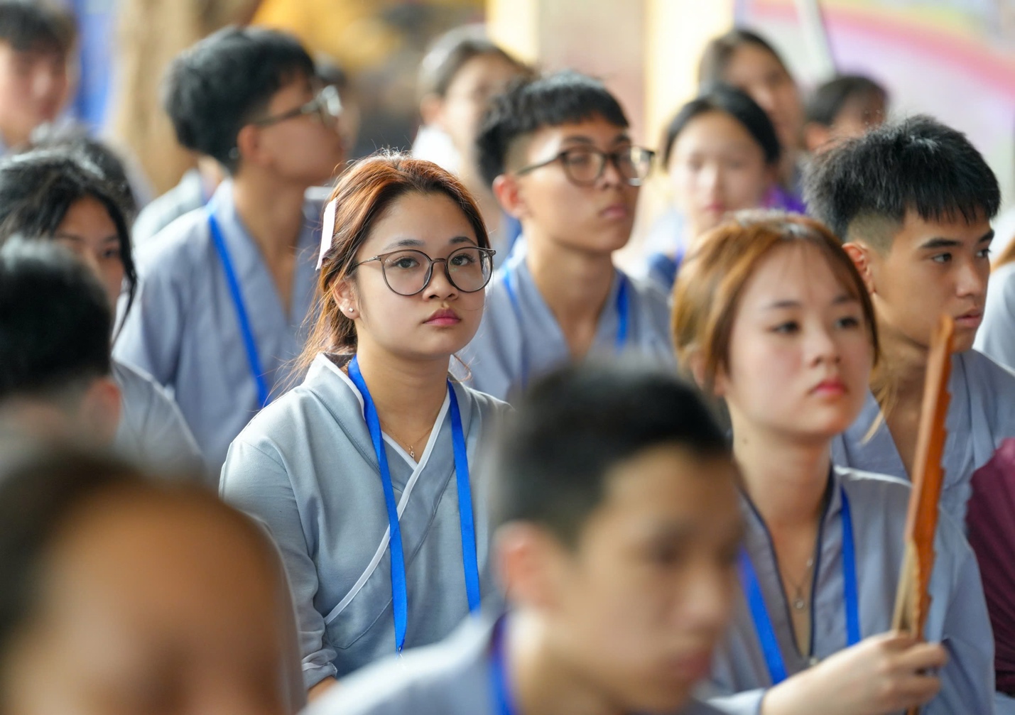 A group of people wearing lanyards AI-generated content may be incorrect.