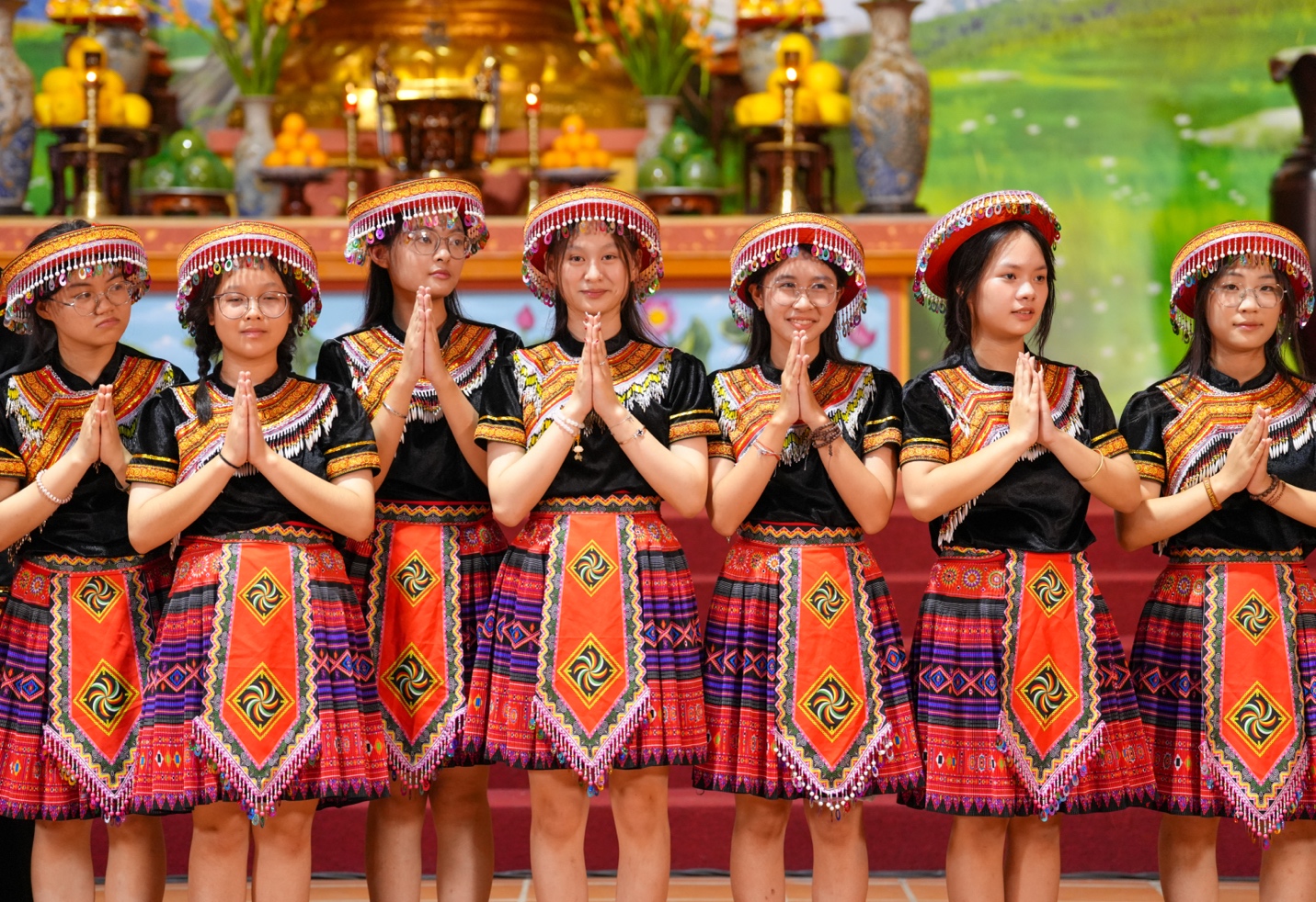 A group of women in traditional clothing AI-generated content may be incorrect.